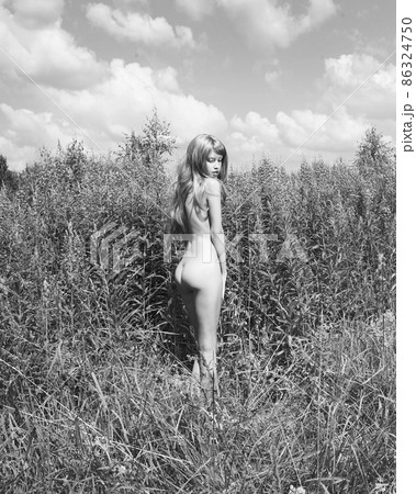 Nude beautiful woman is showing her naked body outside. Nude beautiful woman is showing her naked body outside. 86324750