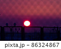 Blurred magenta and purple colored sunset through metal bars 86324867