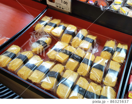 SEREMBAN, MALAYSIA - JANUARY 29, 2022: Selected focused on sushi being displayed for sale in a chiller. Separated in the tray according to type and placed a price tag for the convenience of customers. 86325637