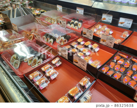 SEREMBAN, MALAYSIA - JANUARY 29, 2022: Selected focused on sushi being displayed for sale in a chiller. Separated in the tray according to type and placed a price tag for the convenience of customers. 86325638