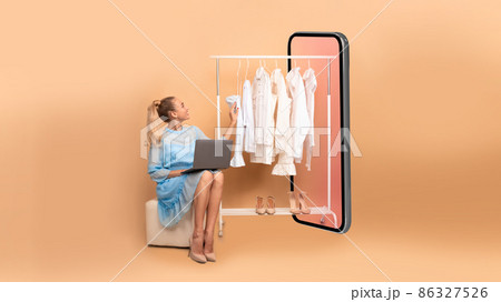 Woman Shopping Online Using Laptop Sitting Near Big Smartphone, Studio 86327526