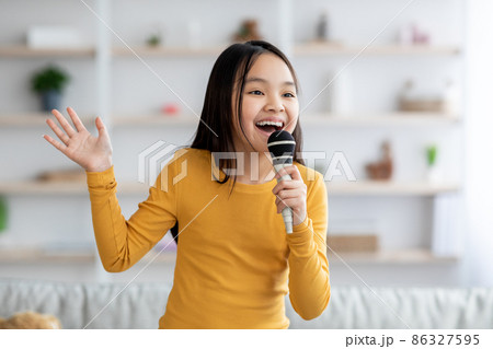 Portrait of cute korean girl teenager singing at home 86327595