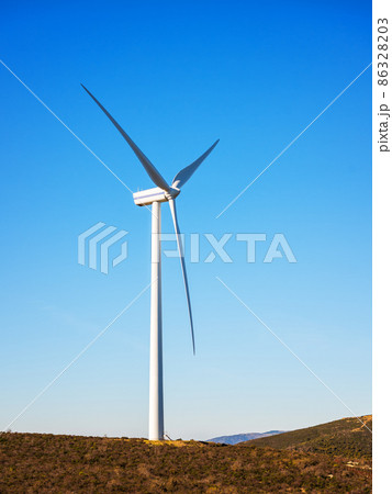 Turbines in a mountain wind farm. Ecological energy production. Turbines in a mountain wind farm. Ecological energy production. 86328203