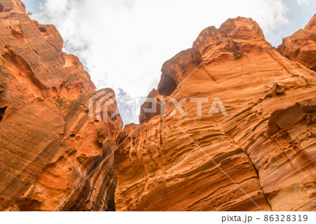 View of the top of the red rocks in Siq passage in Petra, Jordan. View of the top of the red rocks in Siq passage in Petra, Jordan. 86328319