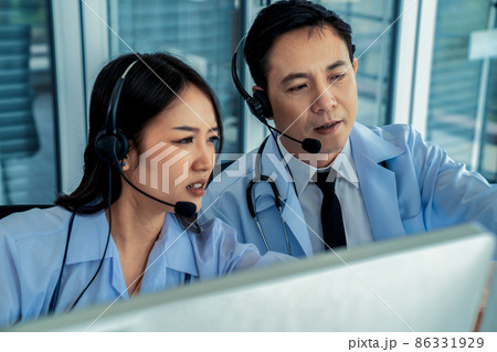 Doctor team wearing headset talking actively on video call in hospital clinic 86331929