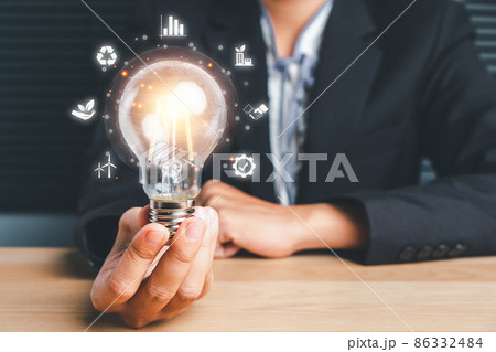 Businesswoman hand holding light bulb with esg icon on virtual screen, ESG Environmental, social and corporate governance concept... Businesswoman hand holding light bulb with esg icon on virtual screen, ESG Environmental, social and corporate governance concept... 86332484