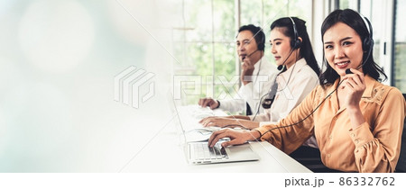 Business team wearing headset working actively in office 86332762