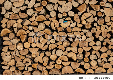 Pile of stacked triangle firewood prepared for fireplace and boiler Pile of stacked triangle firewood prepared for fireplace and boiler 86333465
