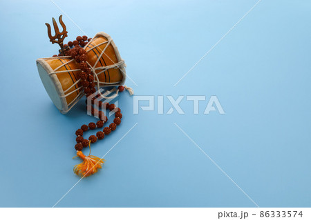 Shivaratri background with Shivas trident and Pellet Drum Damroo musical instrument . Hindu festival Maha Shivratri Shivaratri background with Shivas trident and Pellet Drum Damroo musical instrument . Hindu festival Maha Shivratri 86333574