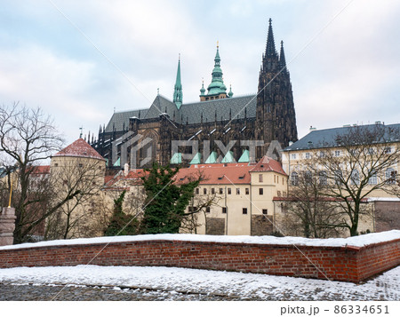 Snowy Prague City with gothic Castle and colorful Trees, Czech Republic Snowy Prague City with gothic Castle and colorful Trees, Czech Republic 86334651