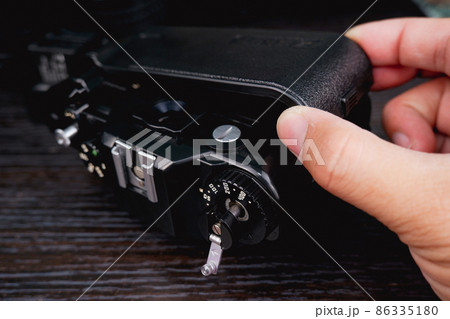 The back cover of the vintage film camera is opened by technical hand 86335180