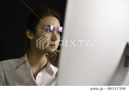 Asian woman sitting looking deep in thought exhausted and tired during working and using computer 86337396