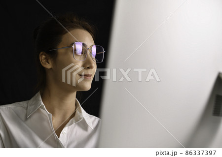 Asian woman sitting looking deep in thought exhausted and tired during working and using computer 86337397