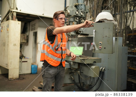 Industry engineer worker operate control heavy machine in factory. 86338139