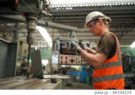 Industry engineer worker operate control heavy machine in factory. 86338229