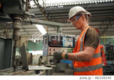 Industry engineer worker operate control heavy machine in factory. 86338240