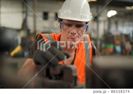 Industry engineer worker operate control heavy machine in factory. Industry engineer worker operate control heavy machine in factory. 86338374