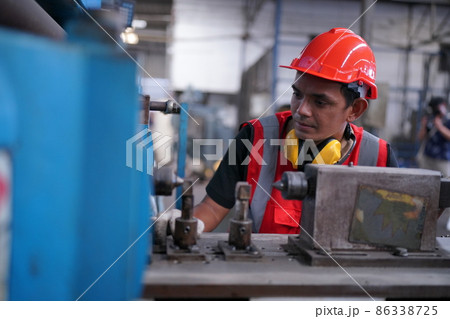 Industry engineer worker operate control heavy machine in factory. Industry engineer worker operate control heavy machine in factory. 86338725