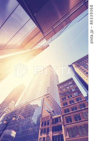 Manhattan old and modern buildings against the sun, color toning applied, New York City, USA. 86339368