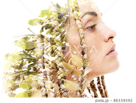 A portrait of a woman dissolving into foliage. Double exposure technique. 86339392