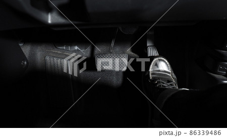 Accelerate and Brake. Foot pressing foot pedal of a car to drive ahead. Accelerator and brake pedal in a car. Driver driving the car by pushing accelerator pedals of the car. inside vehicle automobile 86339486
