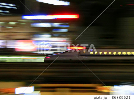 東海道新幹線N700系のぞみ号　東京のネオン輝く夜の中を走る 86339621