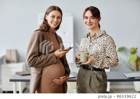 Two colleagues standing at office 86339622