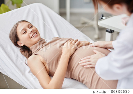 Pregnant woman visiting gynecologist at hospital Pregnant woman visiting gynecologist at hospital 86339659