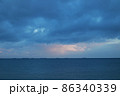 Open sea. Ship boat in the middle of the sea. Cloudy cloudy weather. Water waves. Sun at sea. 86340339