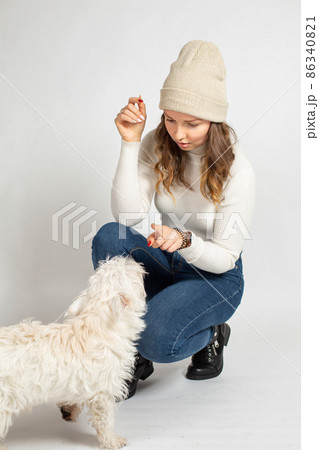 Young woman in warm jumper on white Young woman in warm jumper on white 86340821