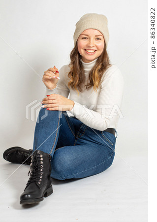 Young woman in warm jumper on white 86340822