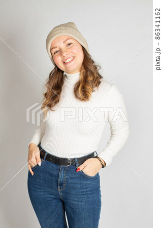Young woman in warm jumper on white Young woman in warm jumper on white 86341162
