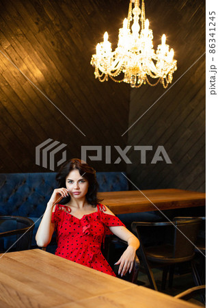 White dark haired woman in dark room White dark haired woman in dark room 86341245
