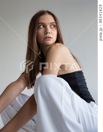 Woman with dark hair on dark grey Woman with dark hair on dark grey 86341829