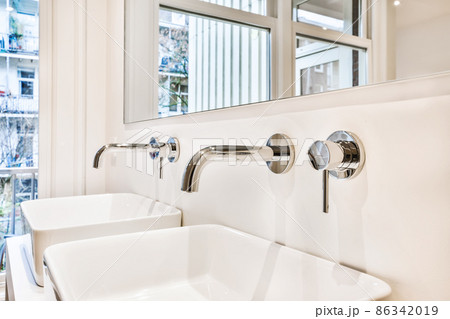 Charming bathroom with two sinks and a huge mirror Charming bathroom with two sinks and a huge mirror 86342019