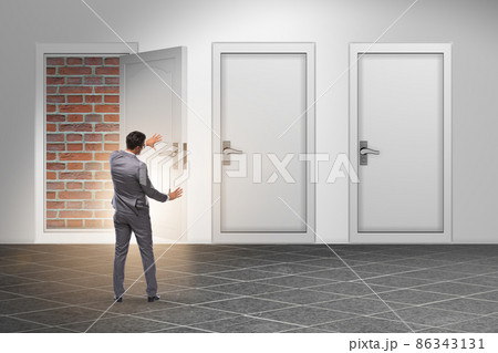 Businessman facing no exit with brick door Businessman facing no exit with brick door 86343131