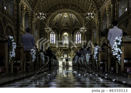 Priest celebrate wedding mass for the Bride and groom at the church. Priest celebrate wedding mass for the Bride and groom at the church. 86350313