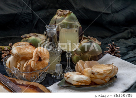 Peel toddy palm and fresh palm juice at front of dark background. Peel toddy palm and fresh palm juice at front of dark background. 86350709