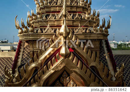 Symmetry view of Loha Prasart Metal Palace at Ratchanaddaram temple through the gate. Loha Prasat Metal Palace is famous tourist destination in Bangkok. Symmetry view of Loha Prasart Metal Palace at Ratchanaddaram temple through the gate. Loha Prasat Metal Palace is famous tourist destination in Bangkok. 86351642