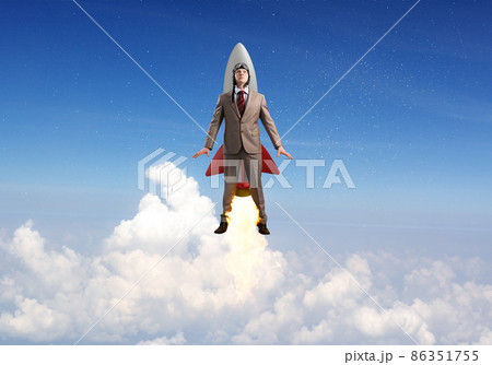 Business person in aviator hat flying on rocket 86351755