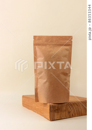 Pouch bag mockup wooden podium neutral beige background monochrome. Blank brown kraft paper pack coffee beans tea leaves Pouch bag mockup wooden podium neutral beige background monochrome. Blank brown kraft paper pack coffee beans tea leaves 86353344