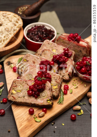 Sliced Traditional French terrine covered with bacon on dark wooden background 86355559