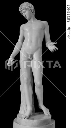Ancient white marble full length sculpture of naked young man. Antique classic statue of youngster isolated on black. Stone figure of teenager 86356405