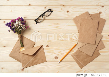 Flowers, blank paper and envelope on a table top 86357580
