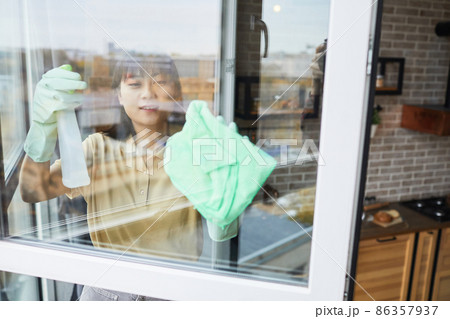 Woman Cleaning Windows at Home Woman Cleaning Windows at Home 86357937