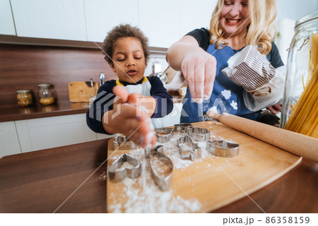 Mom and daughter prepare a baking dish 86358159
