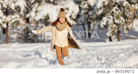 happy child girl runs through the winter snow park happy child girl runs through the winter snow park 86359072