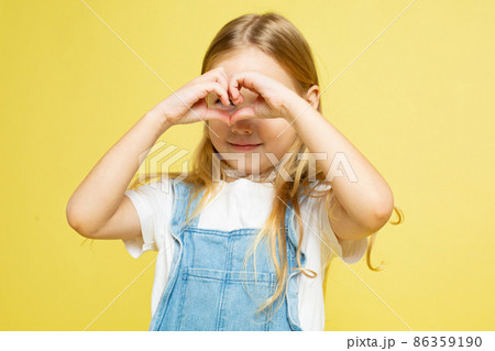 White european baby girl isolated on yellow White european baby girl isolated on yellow 86359190