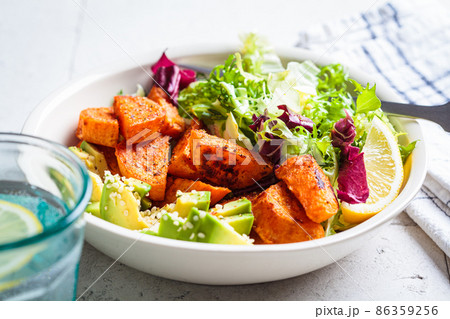 Baked sweet potato slices with avocado and green salad. Healthy vegan food concept. 86359256