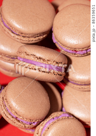 Chocolate macarons on red background. 86359651
